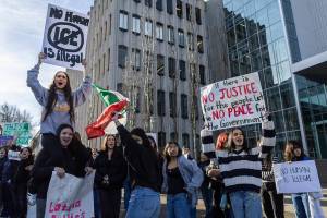 Everett High School students cheer as a car honks during a walkout rally in protest of ICE outside of the Snohomish County Courthouse on Tuesday, Jan. 13, 2026 in Everett, Washington. (Olivia Vanni / The Herald)