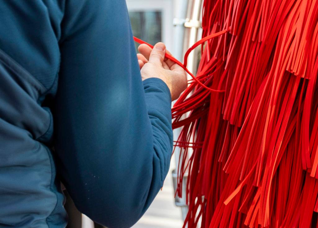 A person touches one of the spinning cleaners at Tommys Express Car Wash on Friday, Jan. 16, 2026 in Everett, Washington. (Olivia Vanni / The Herald)
