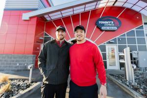 Tommy’s Express Car Wash owners Clayton Wall, left, and Phuong Truong, right, outside of their car wash on Friday, Jan. 16, 2026 in Everett, Washington. (Olivia Vanni / The Herald)