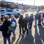 Cars drive past hundreds participating in South Snohomish County Indivisibles Signs of Fascism protest on Tuesday, Jan. 20, 2026 in Edmonds, Washington. (Olivia Vanni / The Herald)