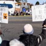 People holds signs along Main Street during South Snohomish County Indivisibles Signs of Fascism protest on Tuesday, Jan. 20, 2026 in Edmonds, Washington. (Olivia Vanni / The Herald)