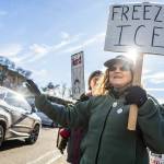 Barbara and Anne Guthrie holds signs and wave at cars offloading from the ferry during South Snohomish County Indivisible’s Signs of Fascism protest on Tuesday, Jan. 20, 2026 in Edmonds, Washington. (Olivia Vanni / The Herald)