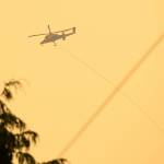 A firefighting helicopter carries a bucket of water from a nearby river to the Bolt Creek Fire on Saturday, Sep. 10, 2022, on U.S. Highway 2 near Index, Washington. (Ryan Berry / The Herald)