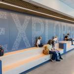 People sit on benches in the main hallway of Explorer Middle Schools athletics building in October, 2025 in Everett. The Mukilteo School Distict is seeking voter approval of a replacement levy for school operations and a $400 million bond measure that will fund construction and improvement projects throughout the district. (Olivia Vanni / The Herald file photo)