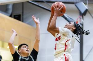 Tulalip Heritage’s JJ Gray makes a layup during the winner-to-state playoff game against Muckleshoot Tribal School on Tuesday, Feb. 18, 2025 in Marysville, Washington. (Olivia Vanni / The Herald)