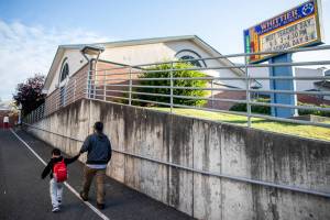 A parent walks their children to class at Whittier Elementary on Wednesday, Sept. 6, 2023 in Everett, Washington. (Olivia Vanni / The Herald)