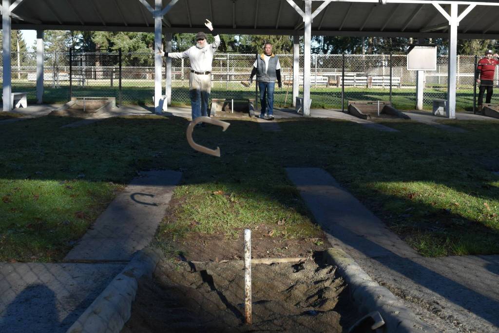 Charlie Tapper, of Auburn, the oldest competitive horseshoe pitcher in Washington at 95 years old, pitches a shoe at a Winetrout Winter Classic tournament at Woodland Park in Seattle, Washington. (Photo courtesy of Melissa Slager)