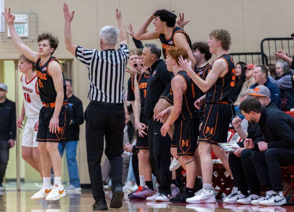 Monroes Wyatt Prohn puts up three fingers after making a three point shot against Snohomish while the Monroe bench reacts behind him during the game on Wednesday, Jan. 28, 2026 in Snohomish, Washington. (Olivia Vanni / The Herald)