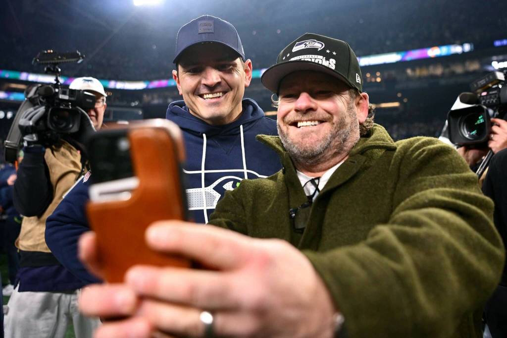 General manager John Schneider takes a selfie with head coach Mike Macdonald after the Seahawks won the NFC Championship game at Lumen Field in Seattle on Sunday, Jan. 25. (Getty Images / The Athletic)