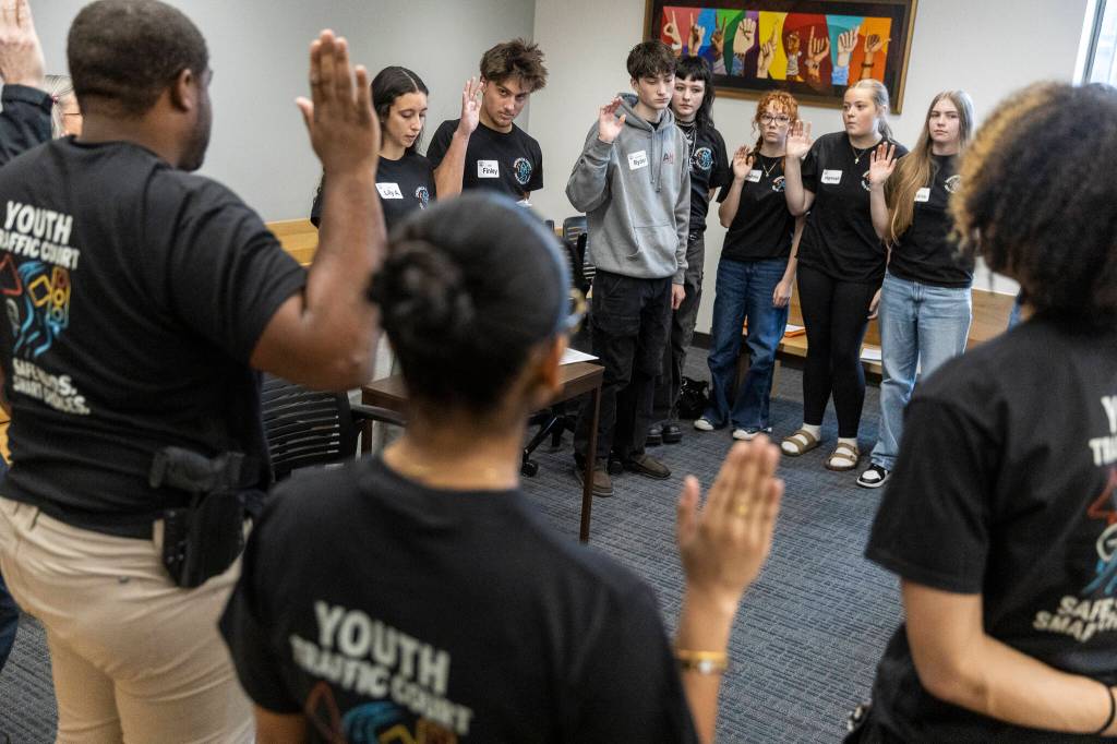 Youth Traffic Court raise their hands to take an oath before the start of the session at the Snohomish County Courthouse on Friday, Jan. 30, 2026 in Everett, Washington. (Olivia Vanni / The Herald)
