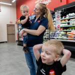 Jerusha Sundem holds her son Micaiah, 1, while her son Elias, 3, talks about his favorite store aisle inside the familys Grocery Outlet store on Tuesday, Feb. 10, 2026 in Everett, Washington. (Olivia Vanni / The Herald)