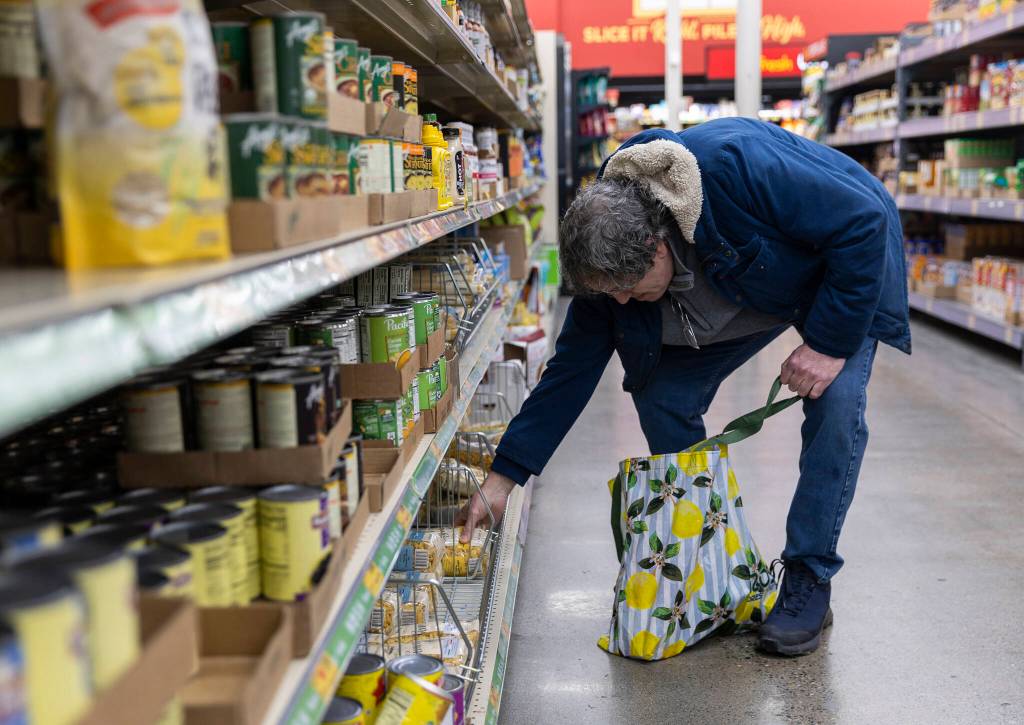 Art Chavez of Everett picks out a selection of pasta from an aisle inside the Grocery Outlet on Tuesday, Feb. 10, 2026 in Everett, Washington. (Olivia Vanni / The Herald)