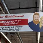 A sign and photo of the Sundems hangs above the main door inside the Grocery Outlet on Tuesday, Feb. 10, 2026 in Everett, Washington. (Olivia Vanni / The Herald)