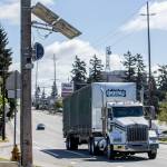 A truck drives west along Casino Road past a new speed camera set up near Horizon Elementary on Wednesday, May 8, 2024 in Everett, Washington. (Olivia Vanni / The Herald)