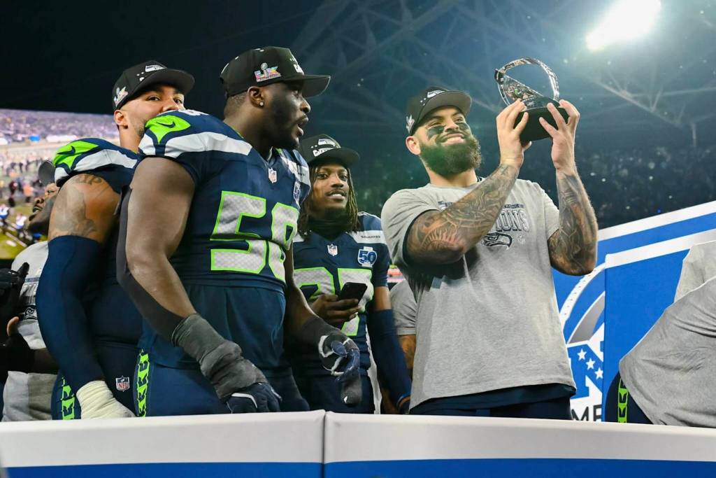 Seattle Seahawks right tackle Abraham Lucas hoists the George Halas NFC Championship Trophy at Lumen Field in Seattle, Washington on Jan. 25, 2026. (Photo courtesy of the Seattle Seahawks)