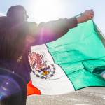 Jazmine Bustos, a sophomore at Lakewood High School, waves a Mexican flag during a student walkout and protest on Thursday, Feb. 5, 2026 in Marysville, Washington. (Olivia Vanni / The Herald)