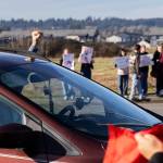 A driver puts a fist in the air while driving past a student walkout and protest on Thursday, Feb. 5, 2026 in Marysville, Washington. (Olivia Vanni / The Herald)