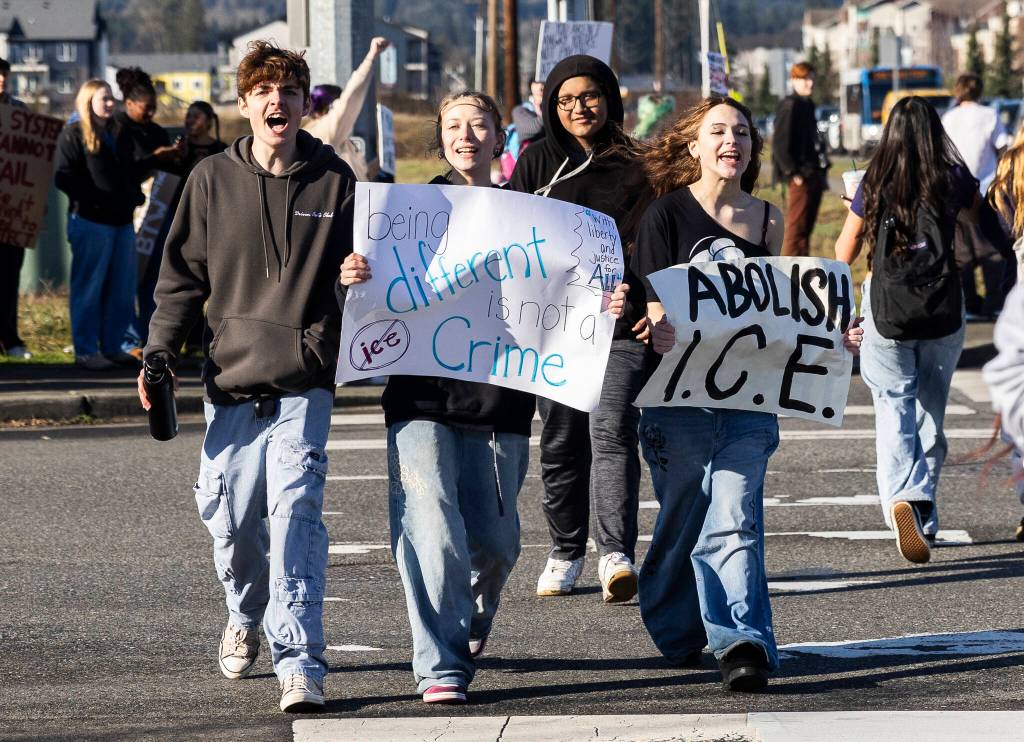 Students holding signs cross 27th Avenue Northeast during a student walkout and protest on Thursday, Feb. 5, 2026 in Marysville, Washington. (Olivia Vanni / The Herald)