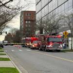 Fire department vehicles park next to the Snohomish County Campus after buildings on the campus were evacuated on Friday. (Jenna Millikan / The Herald)