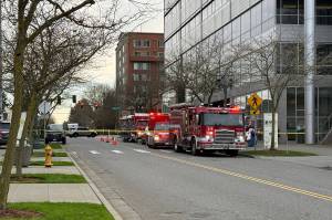 Fire department vehicles park next to the Snohomish County Campus after buildings on the campus were evacuated on Friday. (Jenna Millikan / The Herald)