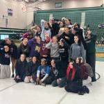 Lake Stevens girls wrestling poses with the District 1 4A Championship trophy on the podium at Jackson High School on Feb. 6, 2026. (Joe Pohoryles/The Herald)