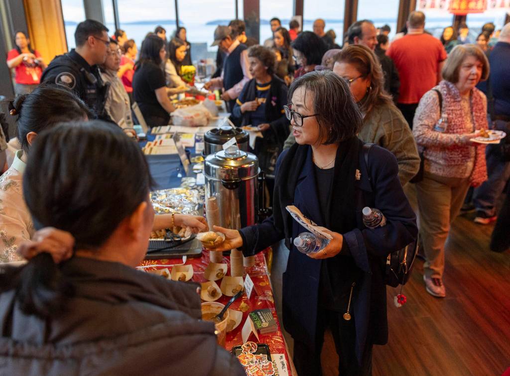 People get free food provided by various restaurants and community members during the City of Mukilteos Lunar New Year Celebration on Thursday, Feb. 12, 2026 in Mukilteo, Washington. (Olivia Vanni / The Herald)