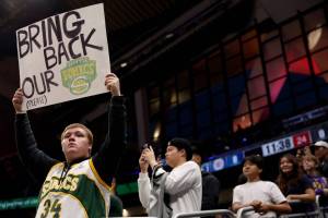 SEATTLE, WASHINGTON - OCTOBER 10: A Seattle Sonics fan holds a sign before the Rain City Showcase in a preseason NBA game between the LA Clippers and the Utah Jazz at Climate Pledge Arena on October 10, 2023 in Seattle, Washington. (Photo by Steph Chambers/Getty Images)