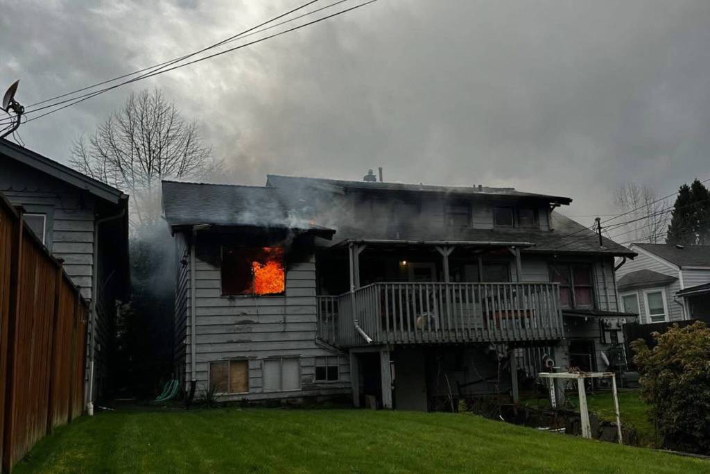Fire can be seen in the window of a triplex on Saturday in the 1100 block of Wetmore Avenue in Everett. (Everett Fire Department)