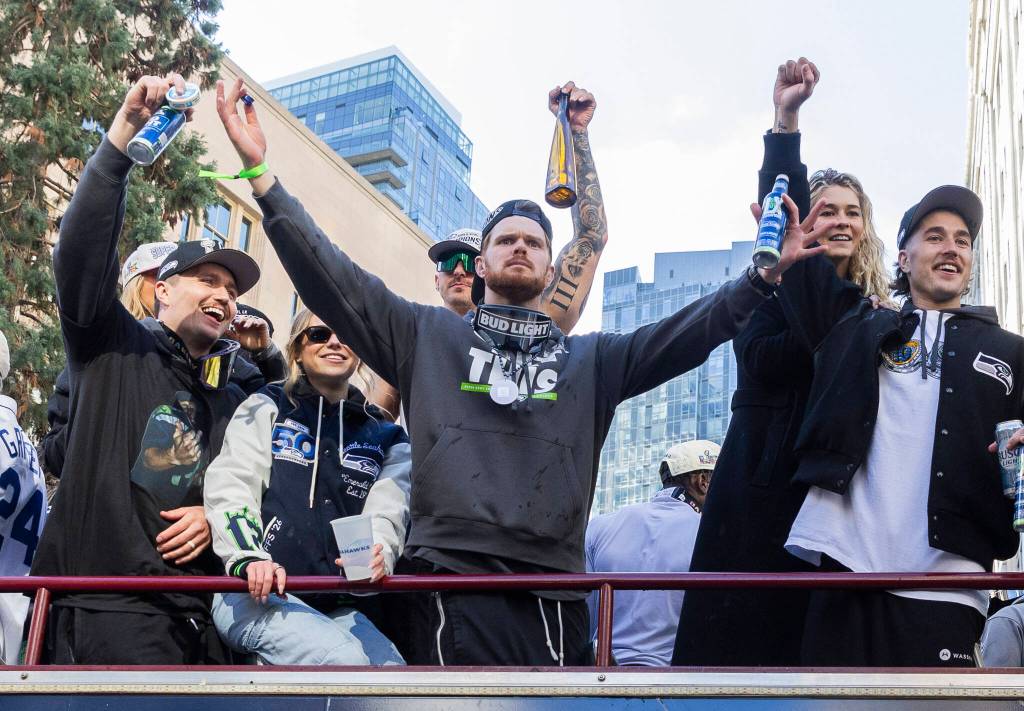 Seattle Seahawks Sam Darnold gestures to the crowd during the Seahawks World Champions Parade on Wednesday, Feb. 11, 2026 in Seattle, Washington. (Olivia Vanni / The Herald)