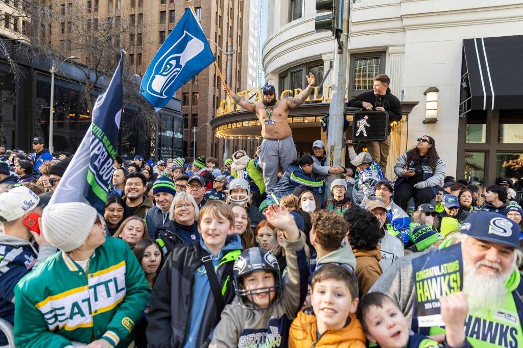 People gather along 4th Avenue before the start of the Seahawks World Champions Parade on Wednesday, Feb. 11, 2026, in Seattle, Washington. (Olivia Vanni / The Herald)