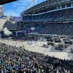 Military cargo truck line Lumen Field in Seattle, Washington, ready to transport Seattle Seahawks players and coaches, during a Super Bowl celebration on Wednesday, Feb. 11, 2026. (Aaron Coe / The Herald)