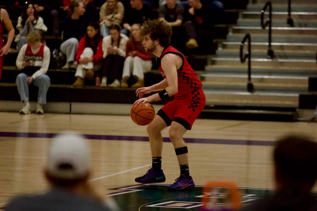 Snohomish junior Grady Rohrich dribbles the ball near midcourt during the Panthers 57-54 win against Monroe in the District 1 3A semifinals at Edmonds-Woodway High School on Feb. 17, 2026. (Joe Pohoryles/The Herald)