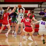 Edmonds-Woodway senior Finley Wichers holds the ball overhead while looking to make a pass during the Warriors 55-47 win against Stanwood in the District 1 3A semifinals at Snohomish High School on Feb. 18, 2026. (Joe Pohoryles/The Herald)