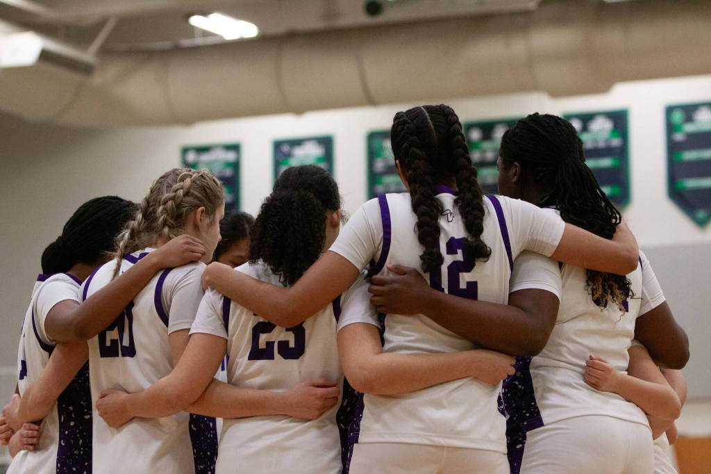 The Lake Stevens girls basketball team huddles before a district playoff game against Glacier Peak on Thursday, Feb. 19, 2026 at Woodinville H.S. in Woodinville. (Qasim Ali / The Herald)