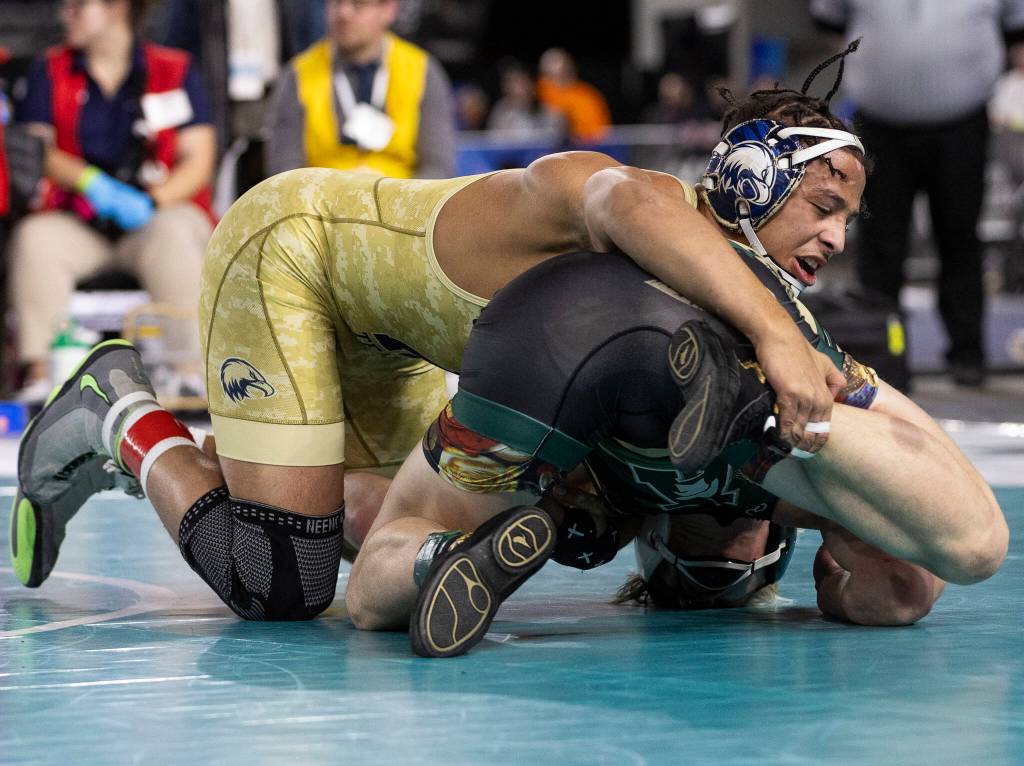 Arlingtons Tre Haines gains control of his opponents leg during the 4A boys 165-pound championship match at the Mat Classic on Friday, Feb. 20, 2026 in Tacoma, Washington. (Olivia Vanni / The Herald)