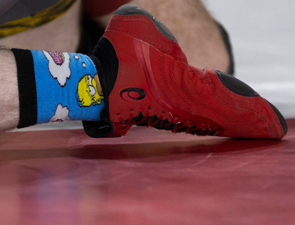 Simpson socks are visible on the ankle of a wrestler at the Mat Classic on Friday, Feb. 20, 2026 in Tacoma, Washington. (Olivia Vanni / The Herald)