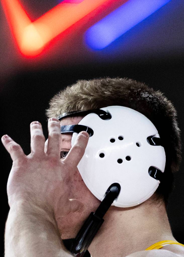 Everetts Alex Buiukli adjusts his ear protection during the 3A boys 165-pound semifinal match at the Mat Classic on Friday, Feb. 20, 2026 in Tacoma, Washington. (Olivia Vanni / The Herald)