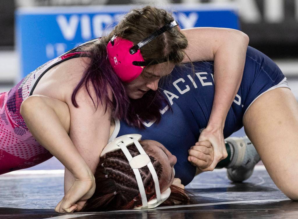 Lake Stevens Kylee Wicklund attempts to pin her opponent during the 4A girls 145-pound championship match at the Mat Classic on Friday, Feb. 20, 2026 in Tacoma, Washington. (Olivia Vanni / The Herald)