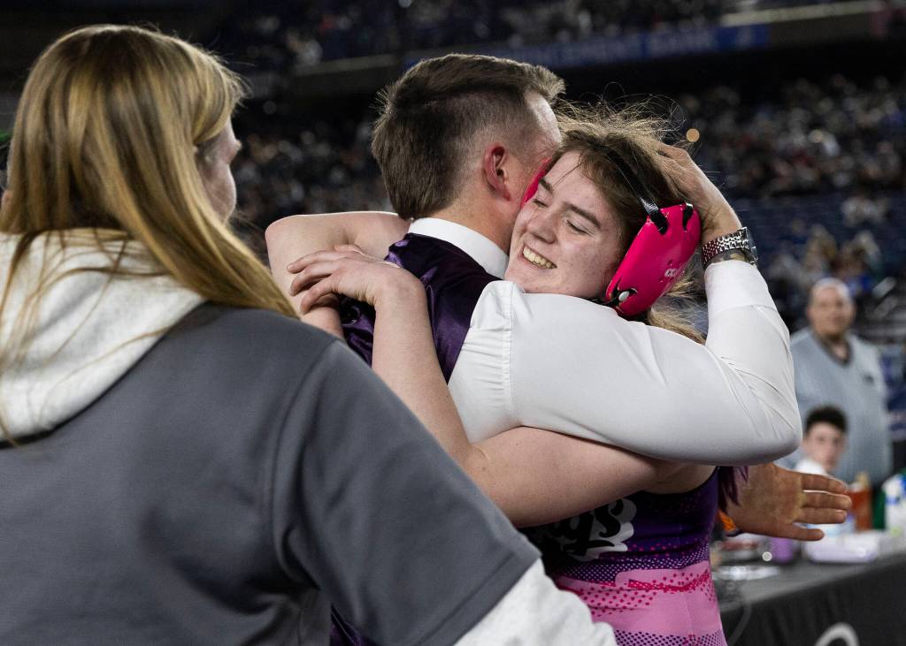 Lake Stevens Kylee Wicklund hugs coach Krys DuPree after winning the 4A girls 145-pound championship match at the Mat Classic on Friday, Feb. 20, 2026 in Tacoma, Washington. (Olivia Vanni / The Herald)