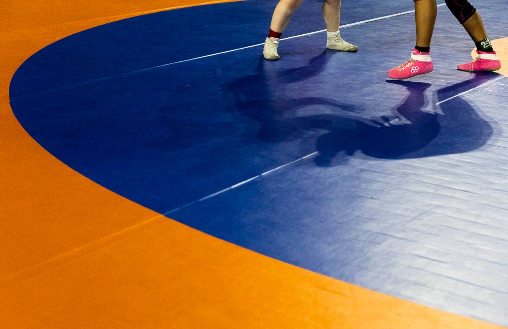 Wrestlers cast shadows during a match at the Mat Classic on Friday, Feb. 20, 2026 in Tacoma, Washington. (Olivia Vanni / The Herald)