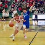 Shorewood junior Thomas Moles (right) applies pressure to Snohomish junior Grant Smith at half court during the Stormrays' 51-36 win against the Panthers in the District 1 3A Championship at Jackson High School on Feb. 21, 2026. (Joe Pohoryles/The Herald)