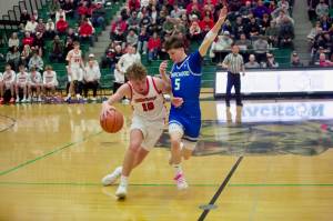 Shorewood junior Thomas Moles (right) applies pressure to Snohomish junior Grant Smith at half court during the Stormrays' 51-36 win against the Panthers in the District 1 3A Championship at Jackson High School on Feb. 21, 2026. (Joe Pohoryles/The Herald)