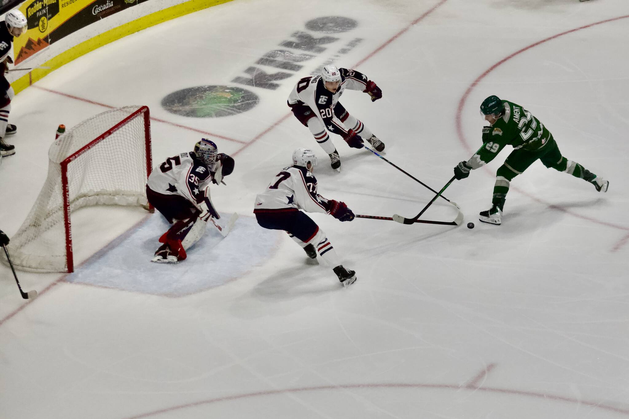 Silvertips forward Henri Ament (right) attempts to get his stick on the puck in front of Tri-City net during Everetts 3-2 win against the Americans at Angel of the Winds Arena on Feb. 22, 2026. (Joe Pohoryles/The Herald)
