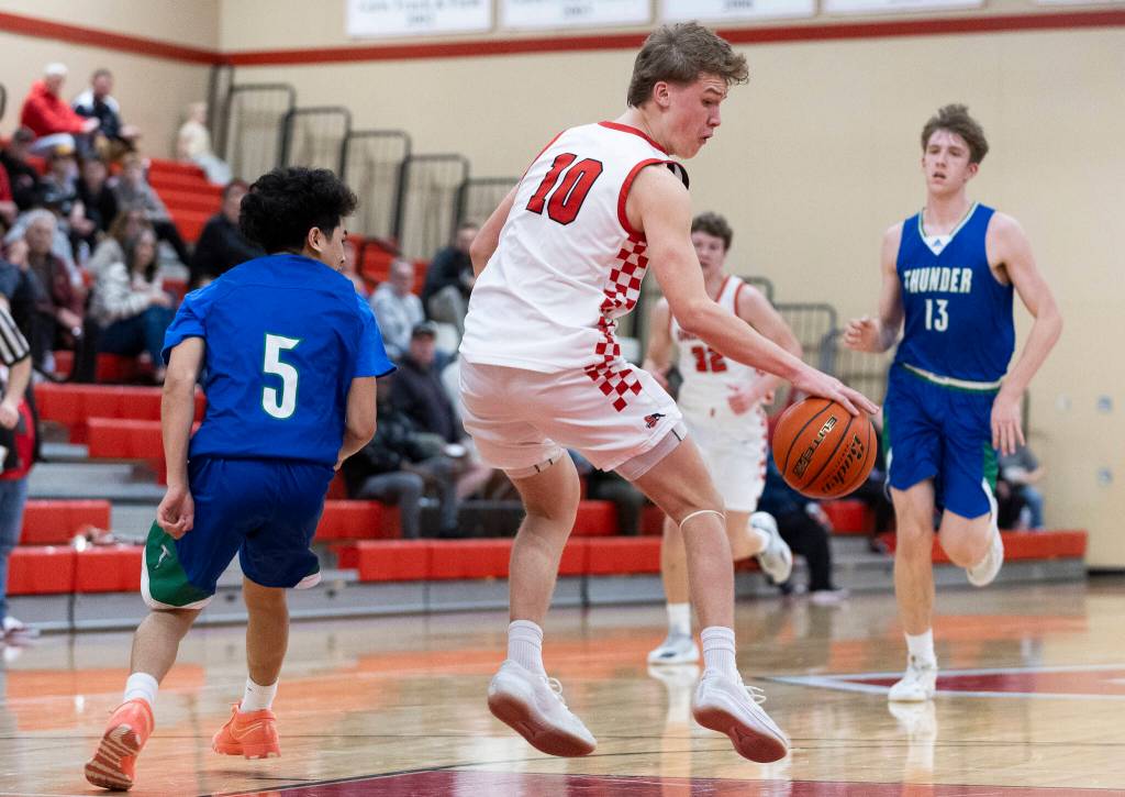 Snohomishs Grant Smith spins around Mountain Views Eli Vongnath has he takes the ball up the court during the 3A state opening round loser-out game on Tuesday, Feb. 24, 2026 in Snohomish, Washington. (Olivia Vanni / The Herald)