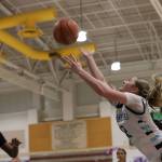 Meadowdales Lexi Zardis is fouled on a layup during a state basketball game against River Ridge on Tuesday, Feb. 24, 2026 at Edmonds-Woodway H.S. in Edmonds. (Qasim Ali / The Herald)