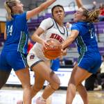 Kings Kaleo Anderson drives to the hoop while Lakesides Bella Tobeck and Emmerson Cummings defend during the 2A state opening round game on Friday, Feb. 27, 2026 in Bothell, Washington. (Olivia Vanni / The Herald)