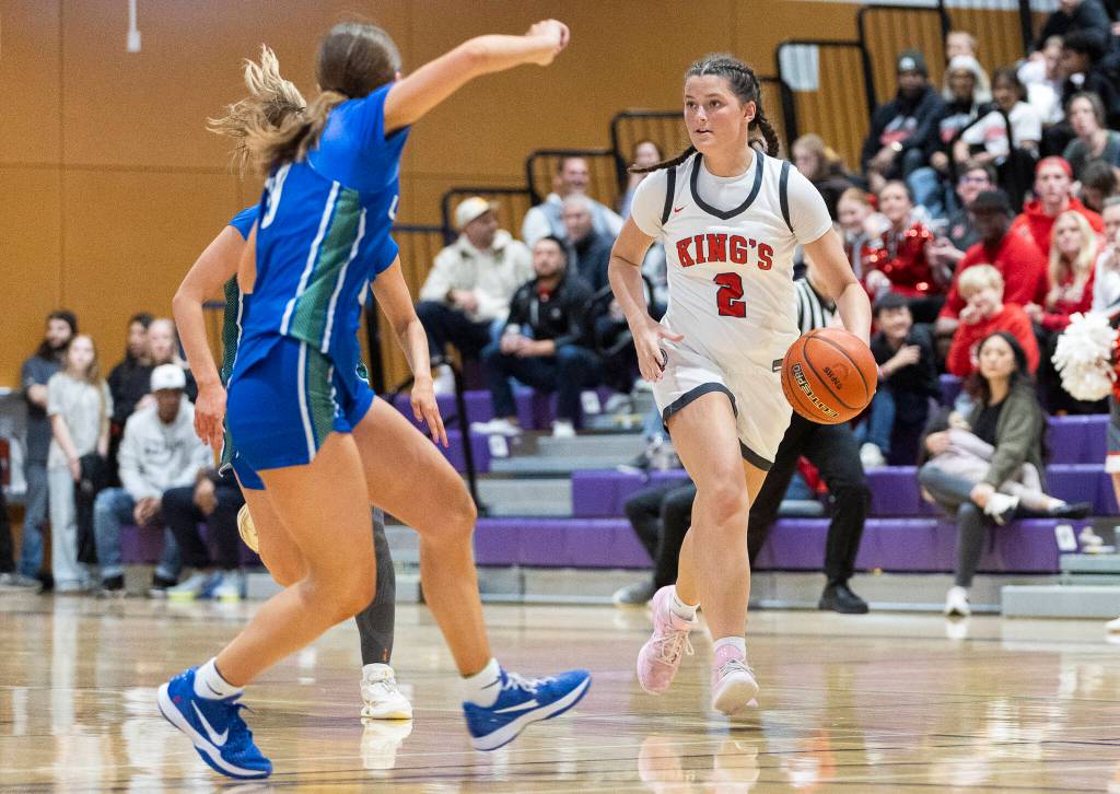Kings Kaitlin Cramer takes the ball up the court during the 2A state opening round game against Lakeside on Friday, Feb. 27, 2026 in Bothell, Washington. (Olivia Vanni / The Herald)