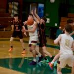 Lakewood senior Caleb Greenland sends a pass out to junior Jaxsen Lang (21) during the Cougars 69-63 overtime loss to the Eagles in the opening round of the 1A Boys State Basketball Tournament at Mount Vernon High School on Feb. 28, 2026. (Joe Pohoryles / The Herald)
