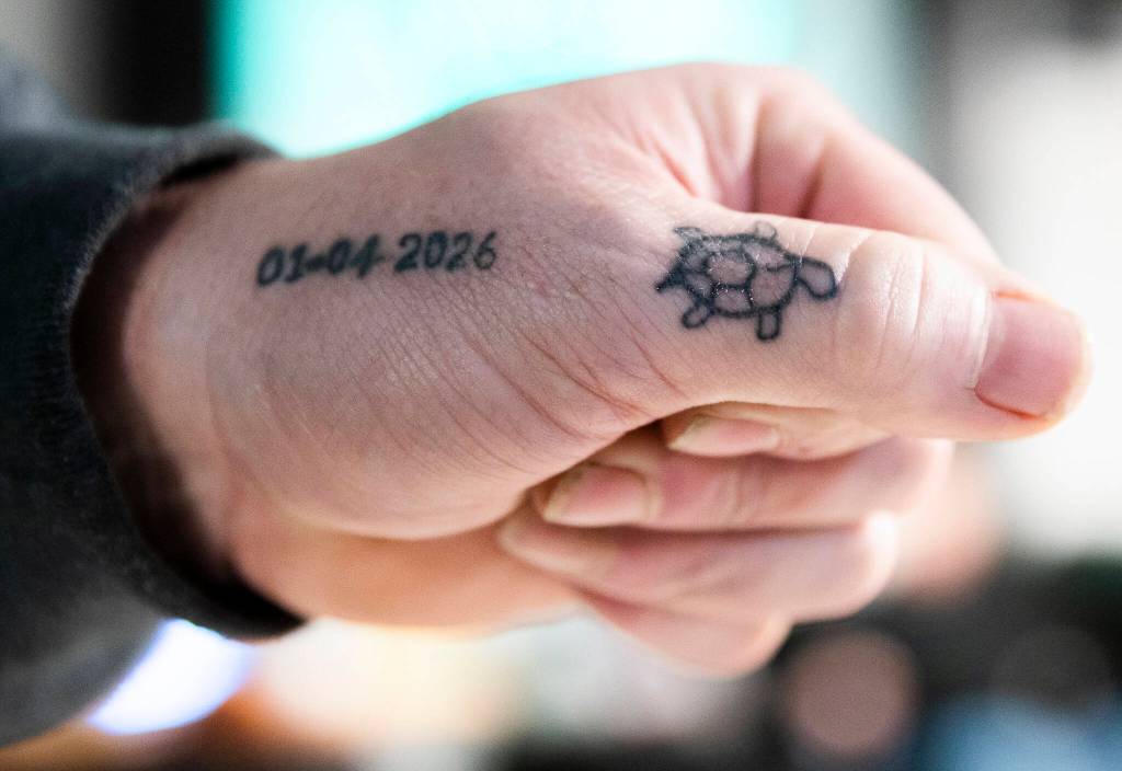 Jeff Turtle Ginnard shows his turtle tattoo next to the date he joined the No Name Riders Motorcycle Club on March 12, 2026, in Everett. (Olivia Vanni / The Herald)