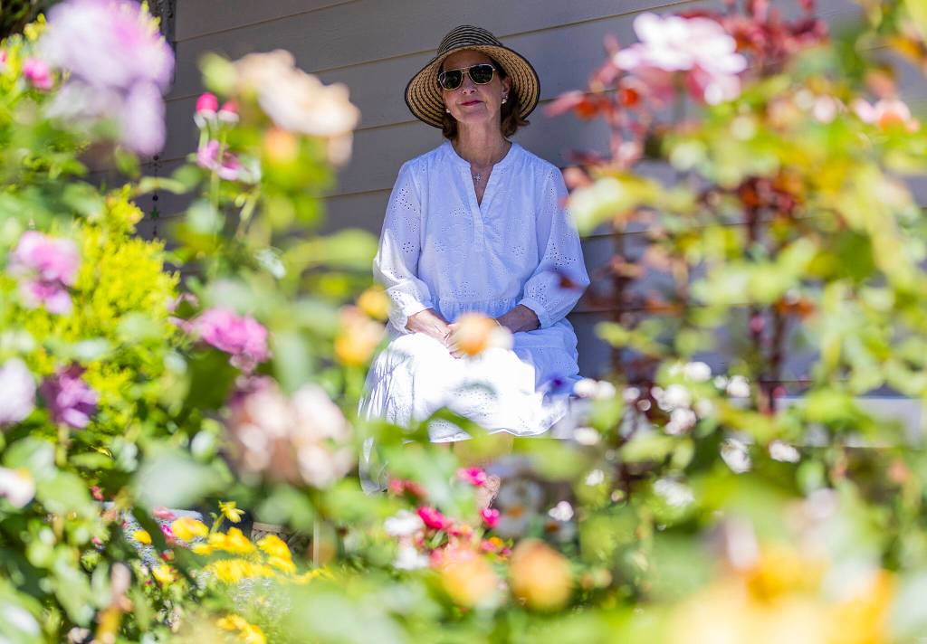 Olivia Vanni / The Herald
Paula Dickman next to her front yard rose garden in August 2025 in Mill Creek.